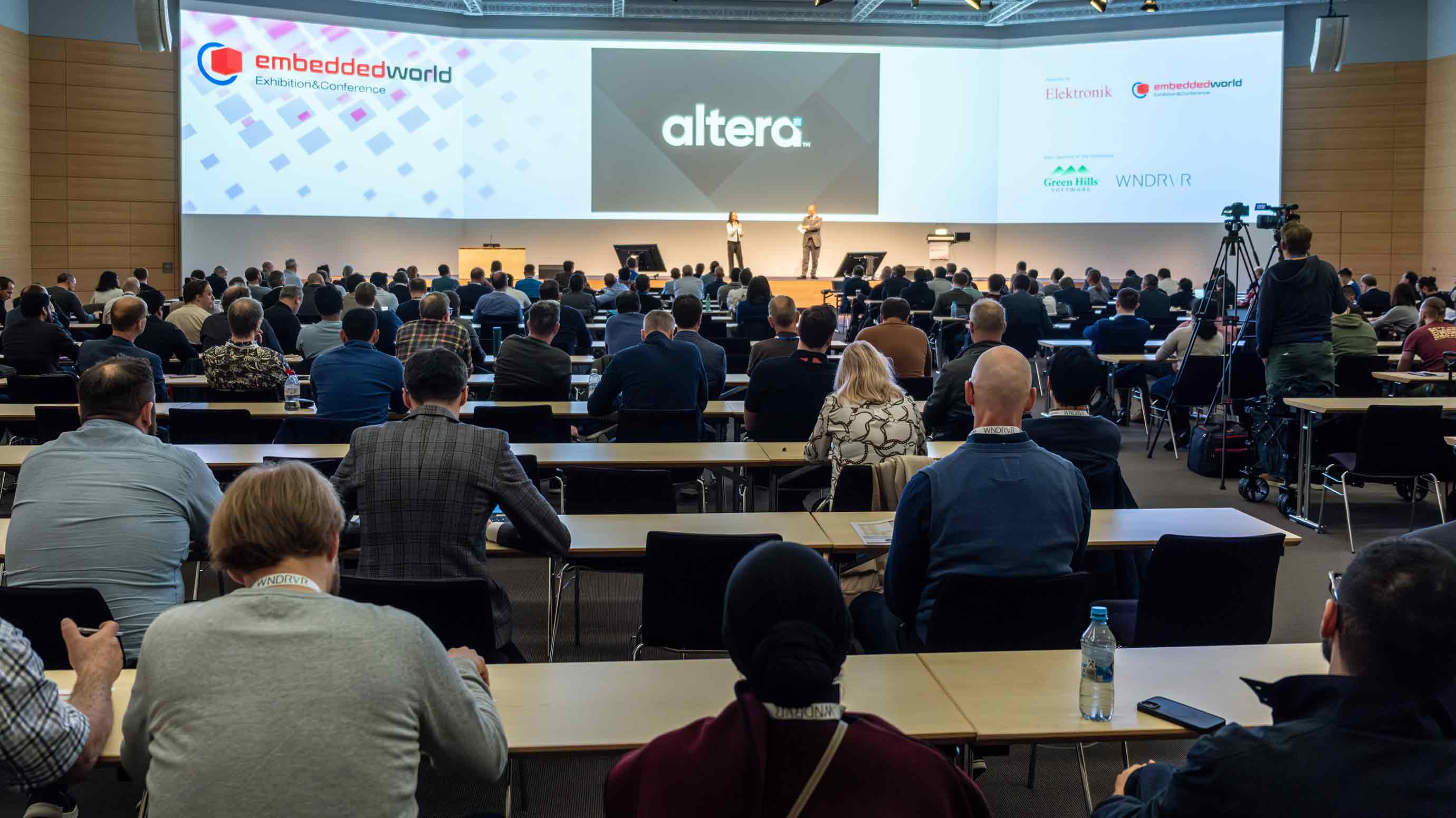 Attendees sitting in chairs, participating at the embedded world conference