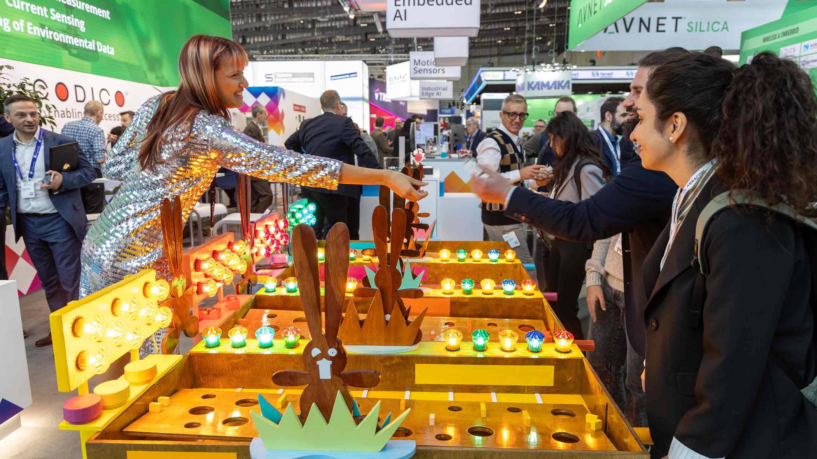 Interactive trade fair installation with colorful lights and game elements engaging visitors.